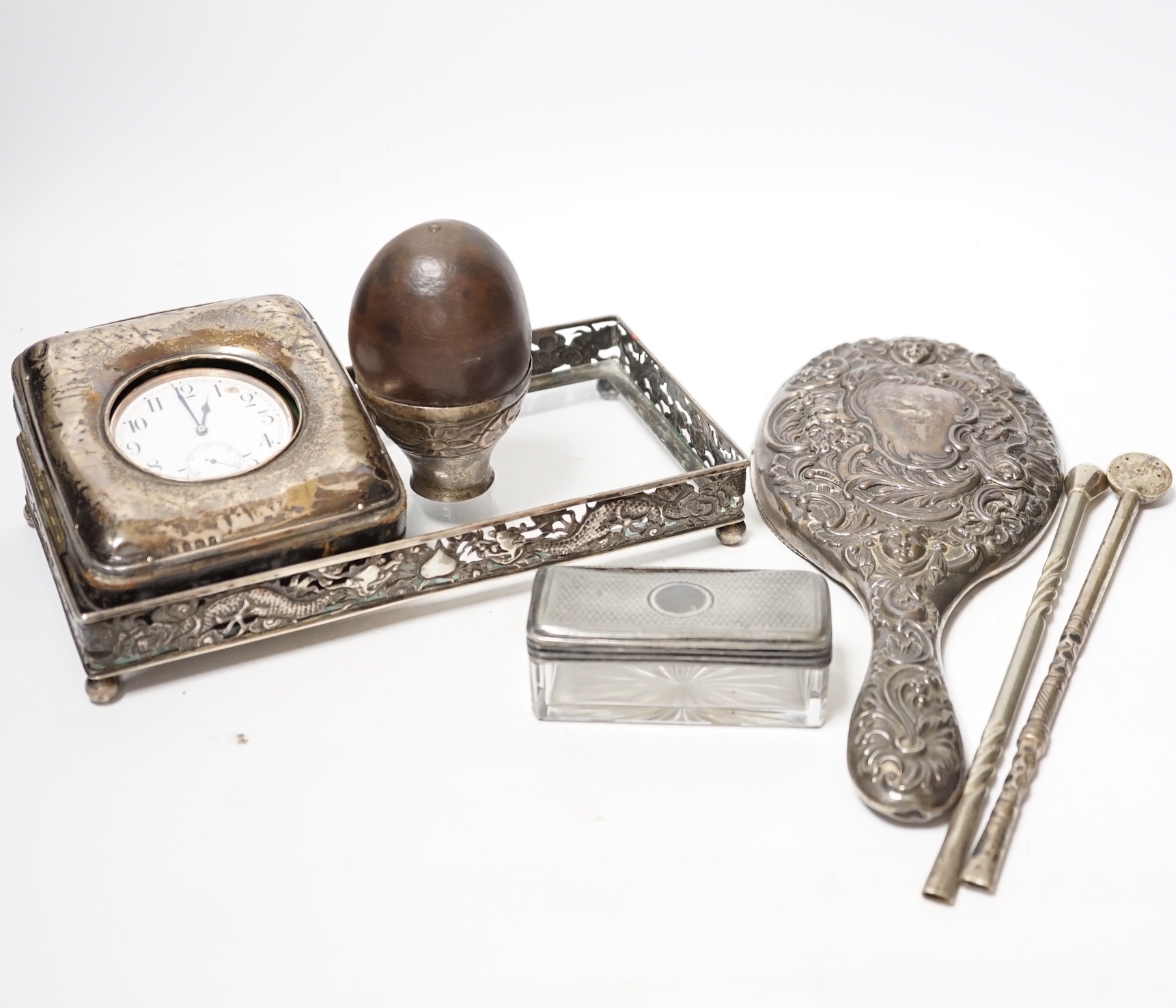 An Edwardian silver mounted travelling pocket watch case, Birmingham, 1905, with nickel cased pocket watch, together with a repousse silver mounted hand mirror, a Chinese white metal mounted glass dressing table tray and